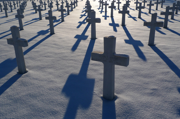 crosses in graveyard, in snow, shadows